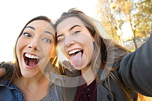 Funny women joking taking selfies in the street photo