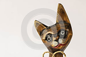 Funny wooden cat on a light background. Close-up