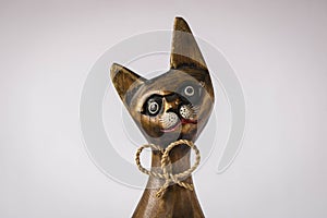 Funny wooden cat on a light background. Close-up