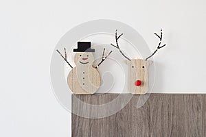 Funny wooden snowman and reindeer