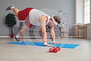 Funny yoga. Fat man doing yoga exercises in the room.