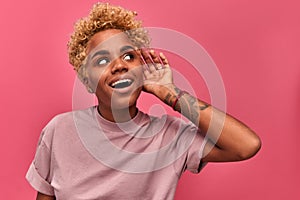 Funny young african american young girl smiling and eavesdrops