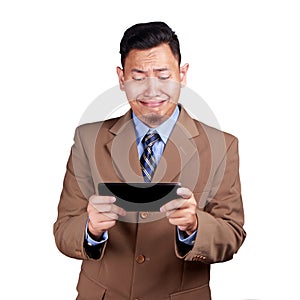 Funny Young Asian Guy Playing Games on Tablet, Crying Sad Expression