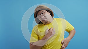 Funny young Asian man feel itchy, scratching his body in pain