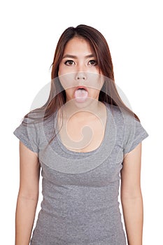 Funny young Asian woman sticking out tongue