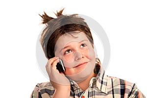 Funny young boy talking on the phone