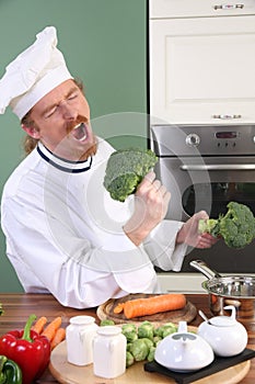 Funny young Chef with broccoli