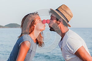 Funny young couple in love on the beach