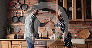 Funny young couple in love dancing fooling in kitchen