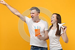 Funny young couple two friends in white empty t-shirts posing isolated on yellow orange background. People lifestyle