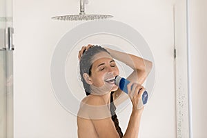 Funny young hispanic female singing aloud while taking shower