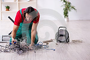 Funny young male electrician working indoors