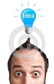 Funny young man with light bulb over his head