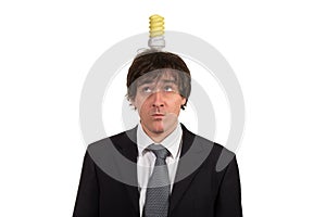 Funny young man with light bulb over his head, isolated on white background