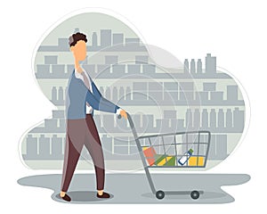 Funny young man with shopping cart buying food at grocery store. Cute boy walking along shelves with products at supermarket.