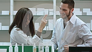 Funny young pharmacist dressed in white uniform dancing at pharmacy