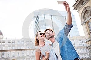 Funny young tourists couple on a walk