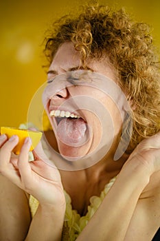 Funny Young Woman Eating Lemon Feel Sour