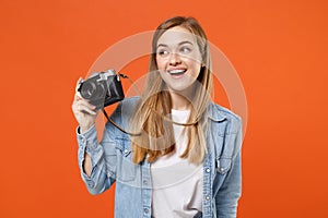 Funny young woman girl in casual denim clothes posing isolated on orange background studio portrait. People sincere