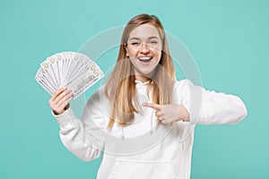 Funny young woman girl in casual white hoodie posing isolated on blue turquoise background. People lifestyle concept