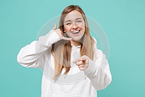 Funny young woman girl in white hoodie isolated on blue turquoise background. People lifestyle concept. Mock up copy
