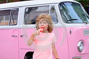 Funy curly child with icecream outdoor. Lovely sweet Caucasian kids outside. photo