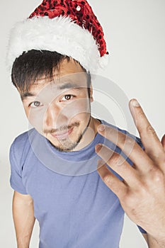 Funy exotical asian Santa claus in new years red