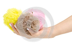 Fur balls yellow pink brown in hand