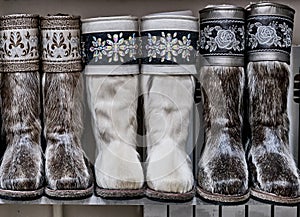 Fur boots made of natural deerskin decorated with floral embroidery with threads or stones.