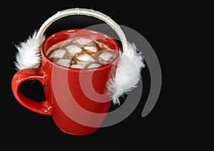 Fur ear muffs on hot cocoa drink