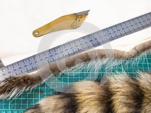 Fur knife and ruler on a pelt on cutting mat