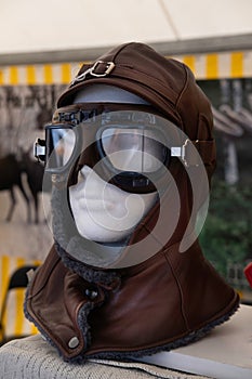 Fur-lined leather windproof aviator hat with matching sunglasses on a styrofoam head