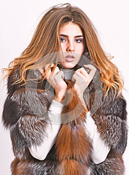 Fur store model enjoy warm in soft fluffy coat with collar. Fur fashion concept. Woman makeup and hairstyle posing mink