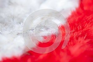 Fur texture background. Red and white fluffy fur diagonally with shallow selective focus in the center.