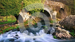Furelos, Spain - The Medieval Bridge Puente San Xoan across the River Furelos, outside Melide in Galicia, on the Way of St James