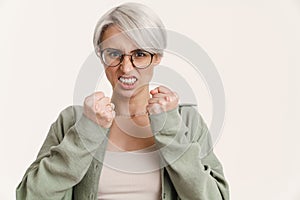 Furious beautiful silver girl posing with clinched fists photo