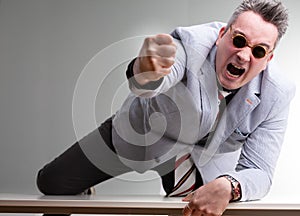 Furious belligerent man punching the camera photo
