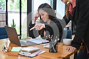 Furious boss manager scolding young frustrated intern with bad work results. Emotional pressure, stress at work concept