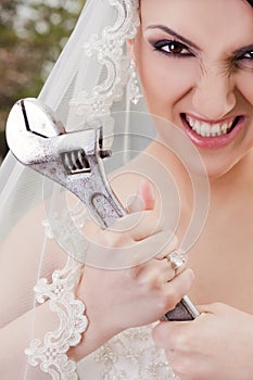 Furious bride holding wrench