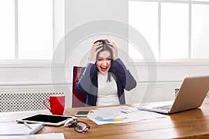 Furious business woman shouting at work place