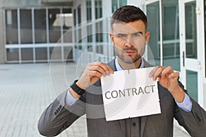 Furious businessman breaking a contract