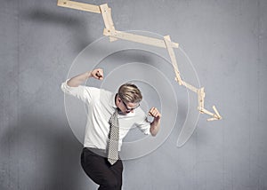 Furious businessman in front of graph pointing down.