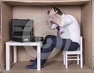 Furious businessman looks into empty briefcase, grabs his head