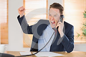 Furious businessman outraged on the phone