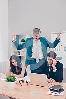 Furious businessman screaming at his colleagues for failed business project