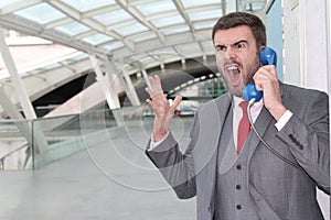 Furious businessman screaming on public phone