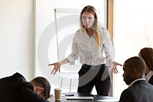 Furious businesswoman confused by employee dozing at briefing