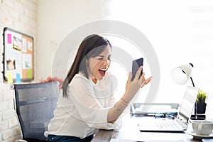 Furious businesswoman yelling into her phone