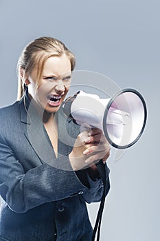 Furious Caucasian Blond Female in Suite Shouting Using Megaphone