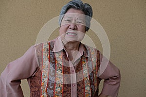 Furious elder woman. enraged elderly female. angry asian senior